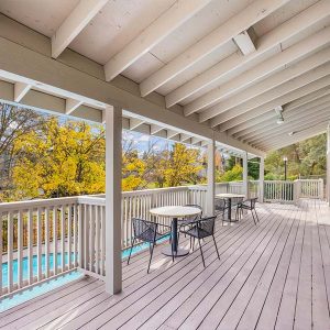 Clubhouse featuring a deck with chairs and tables